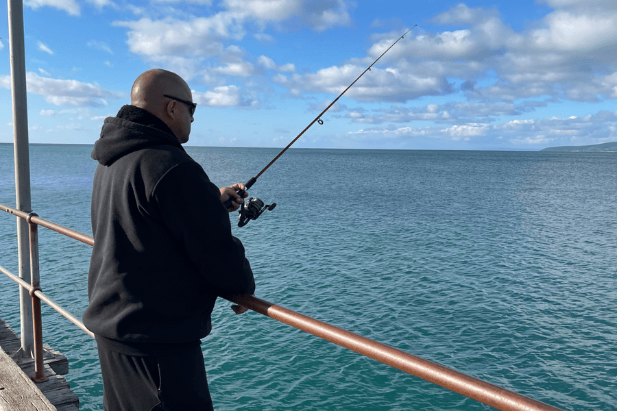Vana Care participant Luke fishing from a South Australian jetty